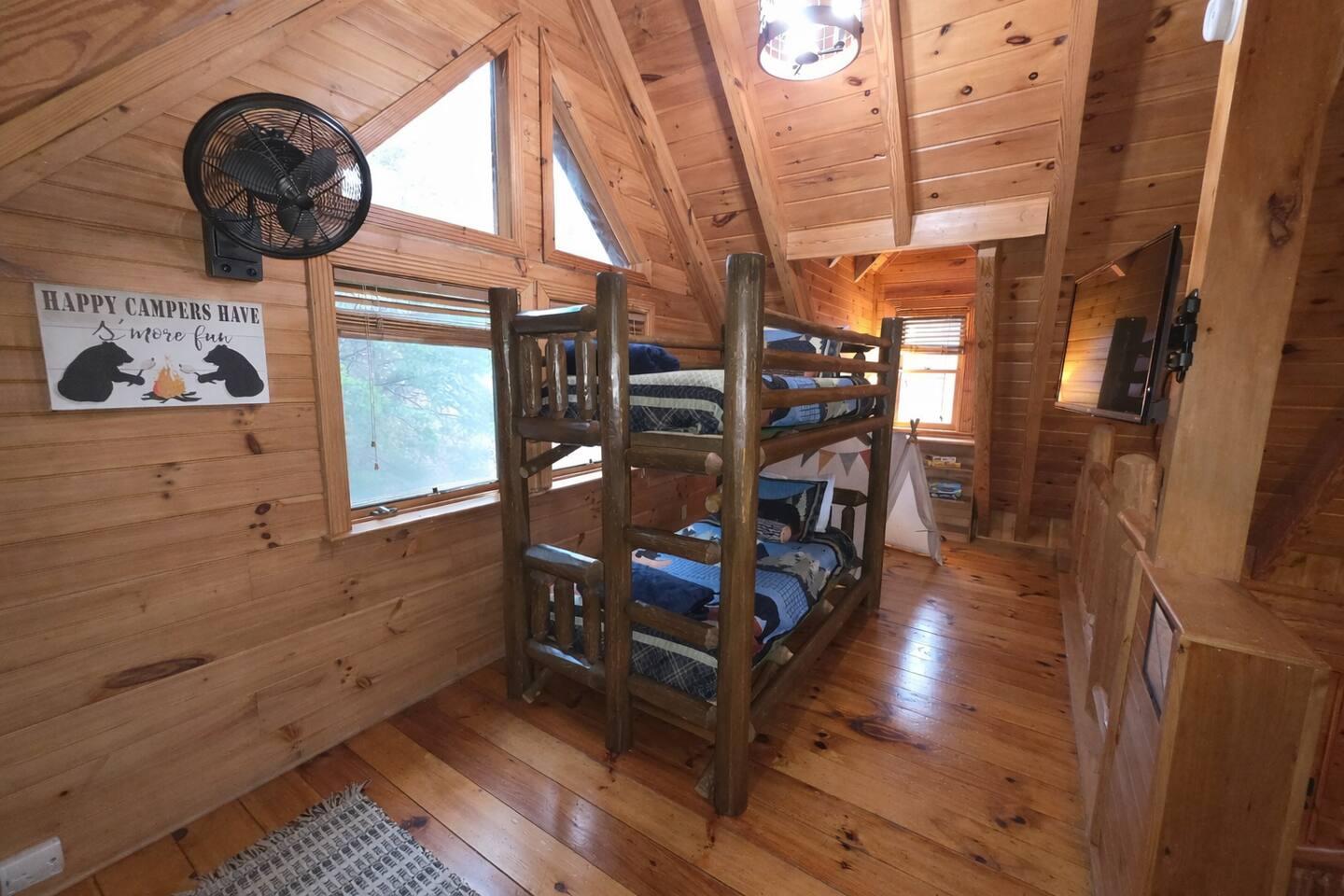 Loft with twin bunk beds and arcade game