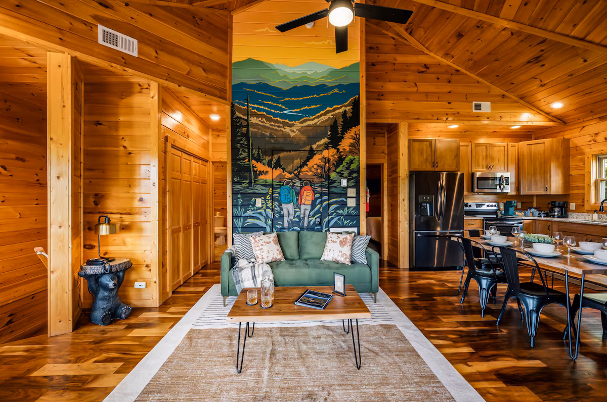 Open-concept living, dining, and kitchen — all wrapped in warm cabin wood.